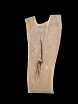 A short irregular shaped walnut slab with a black background. 