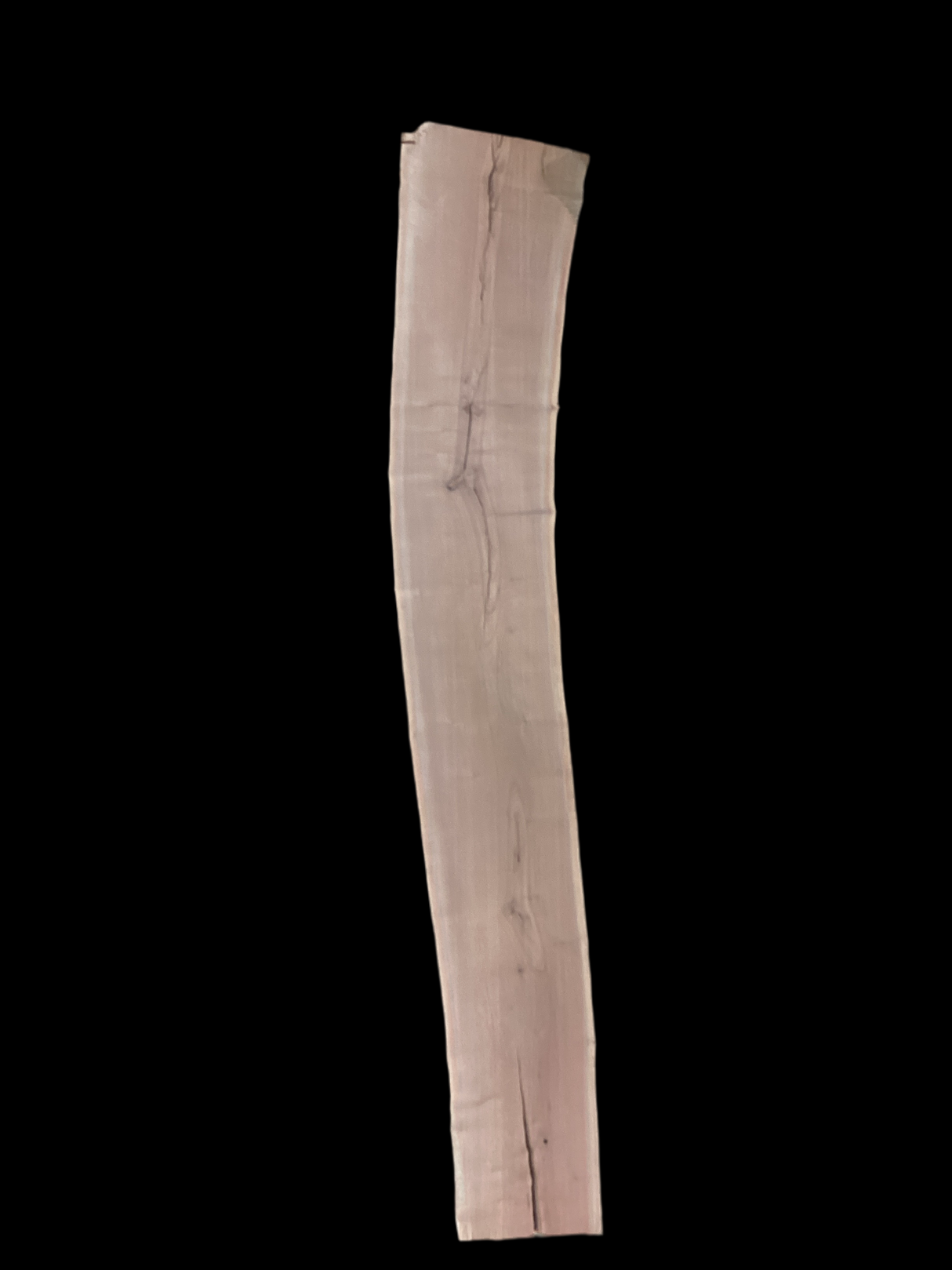 A long walnut wood slab on a black background.