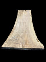 A beige-colored, solid-wood red oak slab with marked dimensions on it, indicating its size and shape.