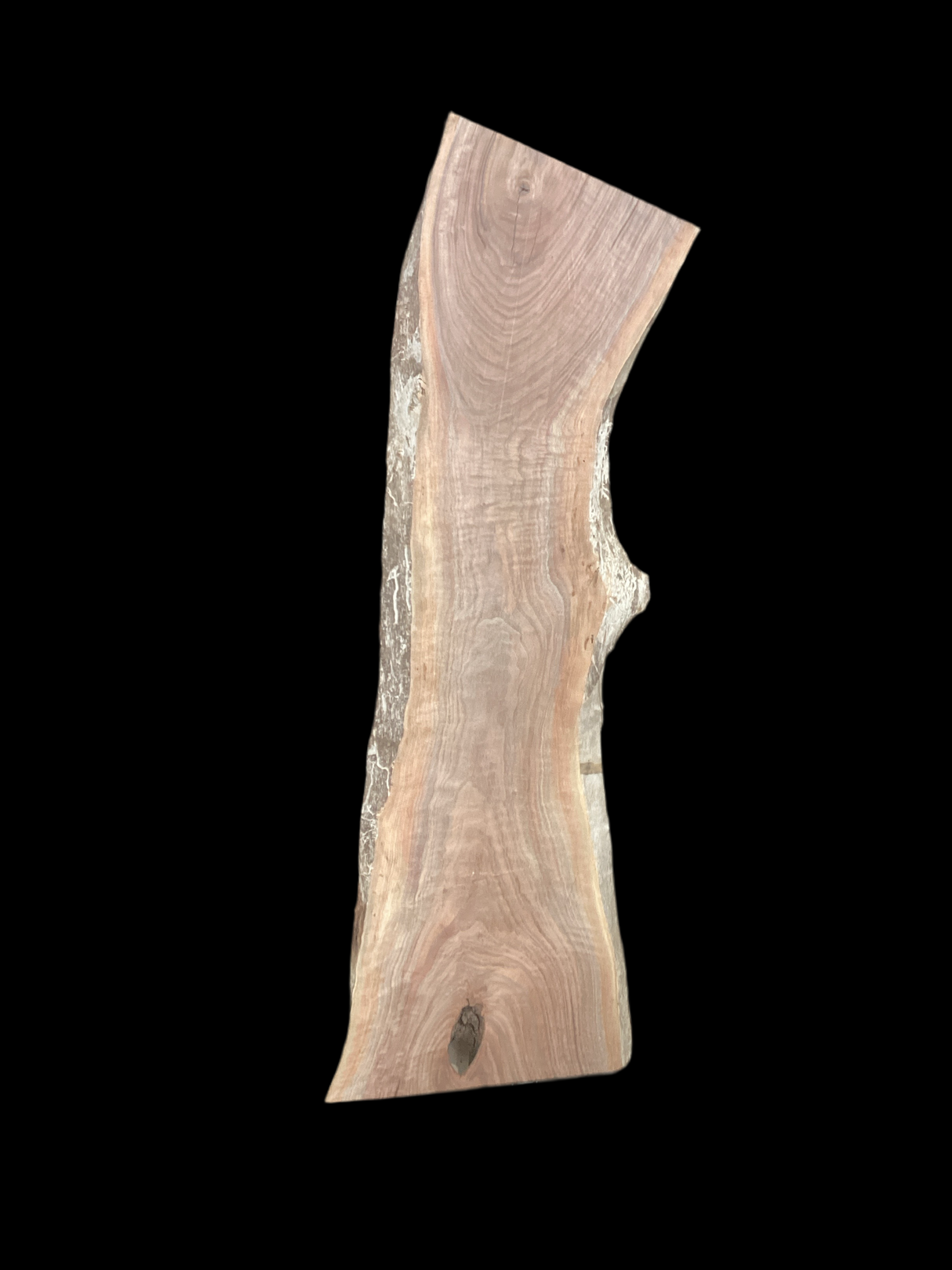 A short walnut slab with a black background.