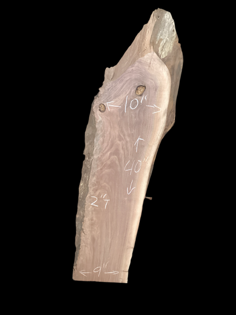 Large walnut wood slab with a black background.