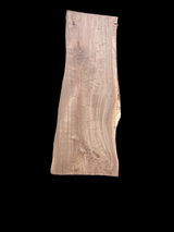 A short walnut slab with a black background.