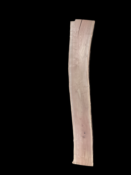 Walnut wood slab on a black background.