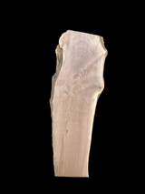 Large walnut wood slab with a black background.