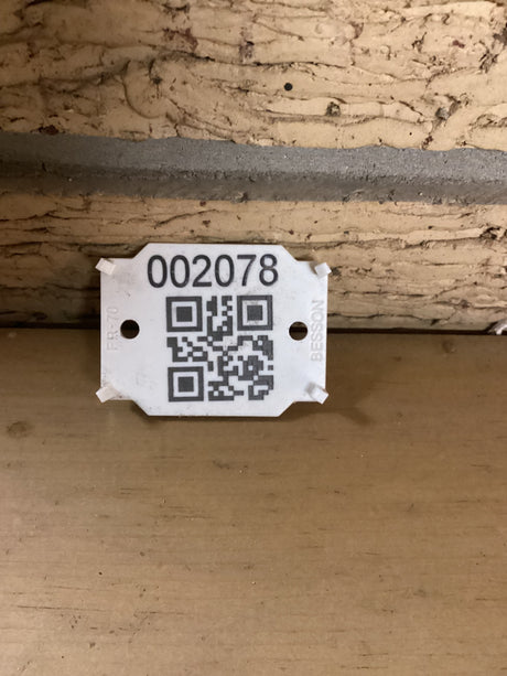 QR code with the sku 2078 positioned against a brick wall.