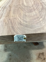 A walnut wood slab with a visible wood grain pattern, tagged with a label that includes a QR code and a number.