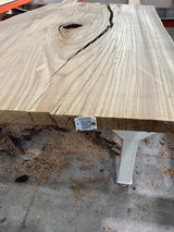 A section of an American Elm wood edge with a QR code attached.