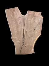 An irregularly shaped walnut slab with a distinctive striped figure pattern on a black background.