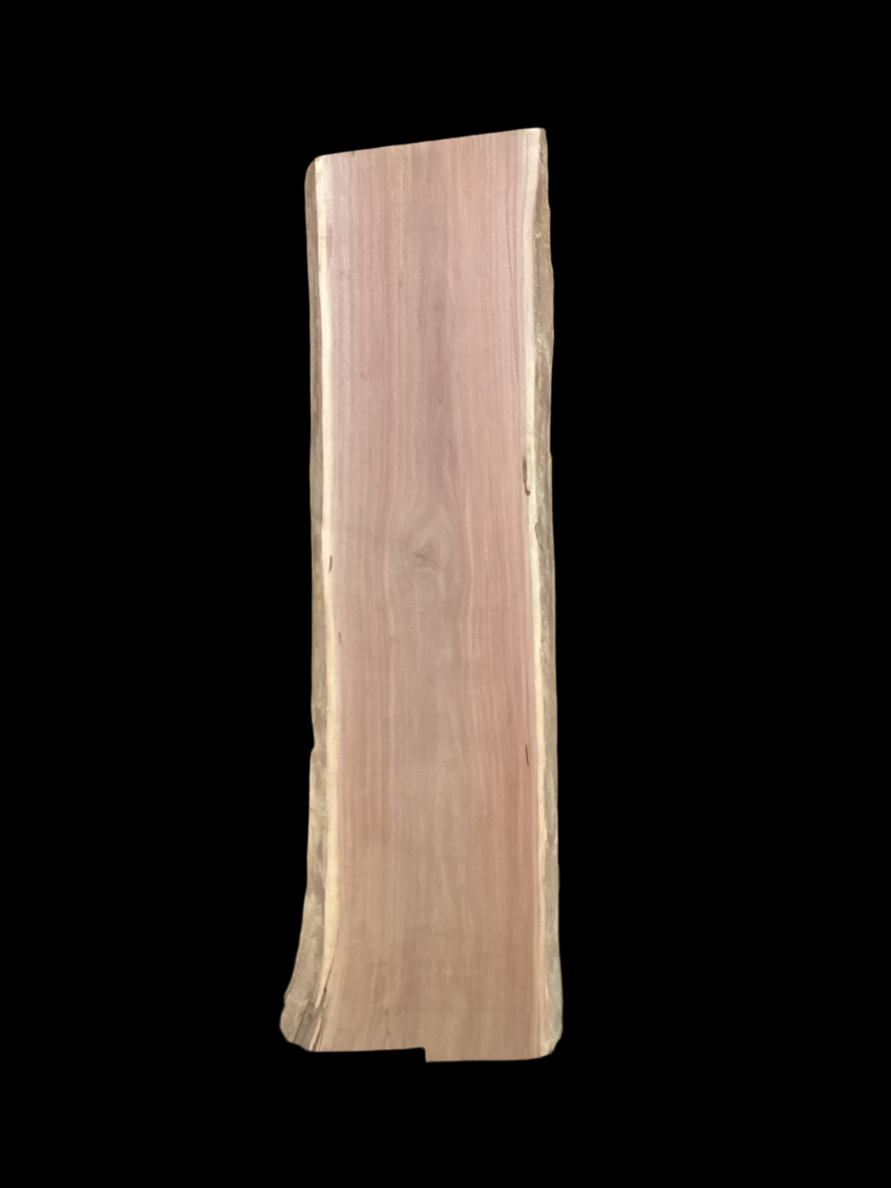 Large walnut wood slab with a black background.