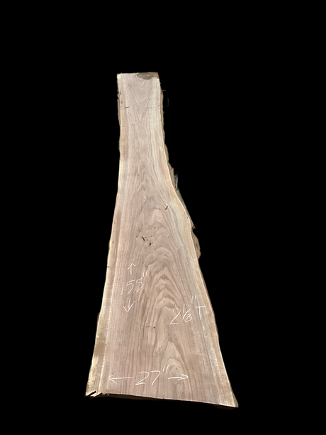 Large walnut wood slab with a black background.