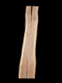 A long walnut wood slab with a split down the middle on a black background.