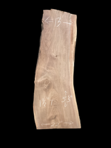A large walnut slab with a black background.