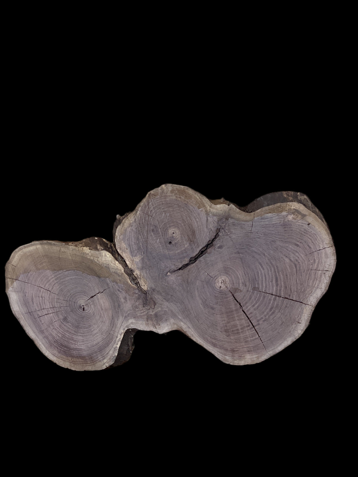 A unique, round walnut coffee table with three distinct heart-shaped centers, each displaying a different grain pattern.