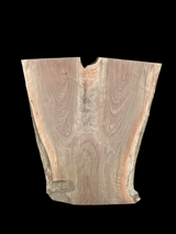 An irregularly shaped walnut slab with a distinctive striped figure pattern on a black background.