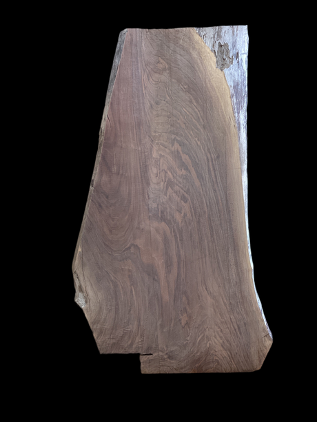 A walnut wood slab positioned against a black background.