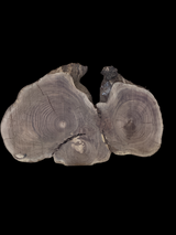 A unique, round walnut coffee table with three distinct heart-shaped centers, each displaying a different grain pattern.