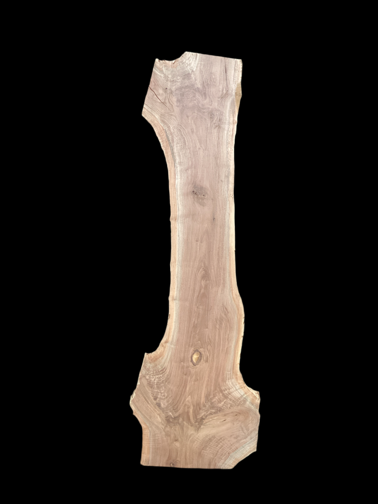 A large walnut slab with a black background.