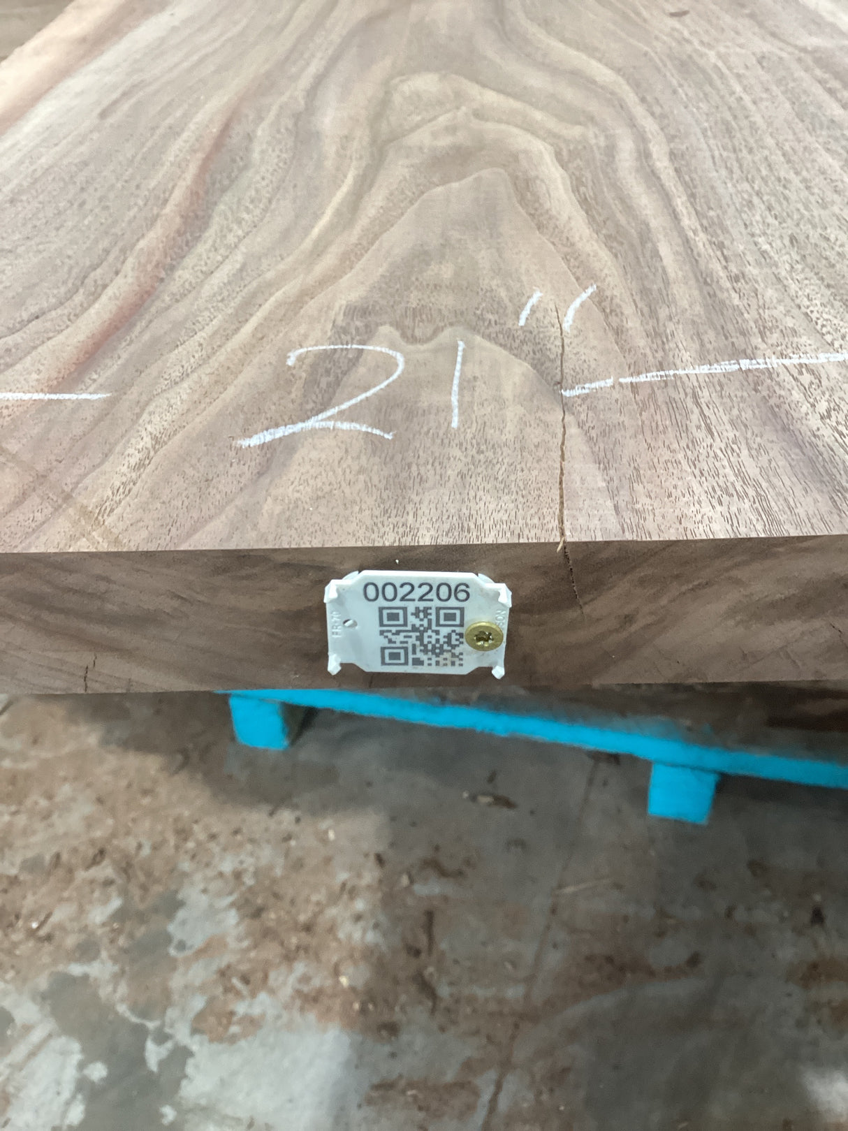 A walnut wood slab with visible natural grain patterns, marked with a measurement of 21' and a QR code.