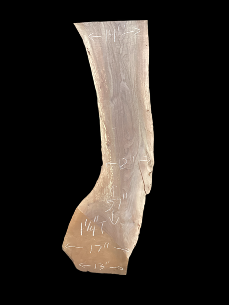 Large walnut wood slab with a black background.