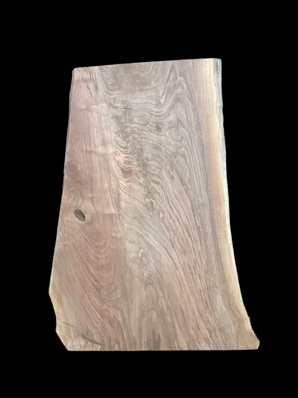 A short walnut slab with a black background.