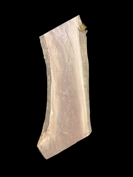 Walnut wood slab with a black background.