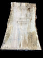 A Silver Maple wood slab with natural edges and some form of measurement or design markings on it.