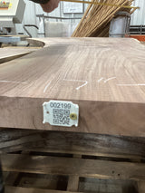 A walnut slab with a unique figure and patterns, featuring a tag with a QR code attached to the side.