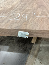 A walnut slab with visible live edge marked with the measurement '29 inches' and a QR label indicating the product type and size.