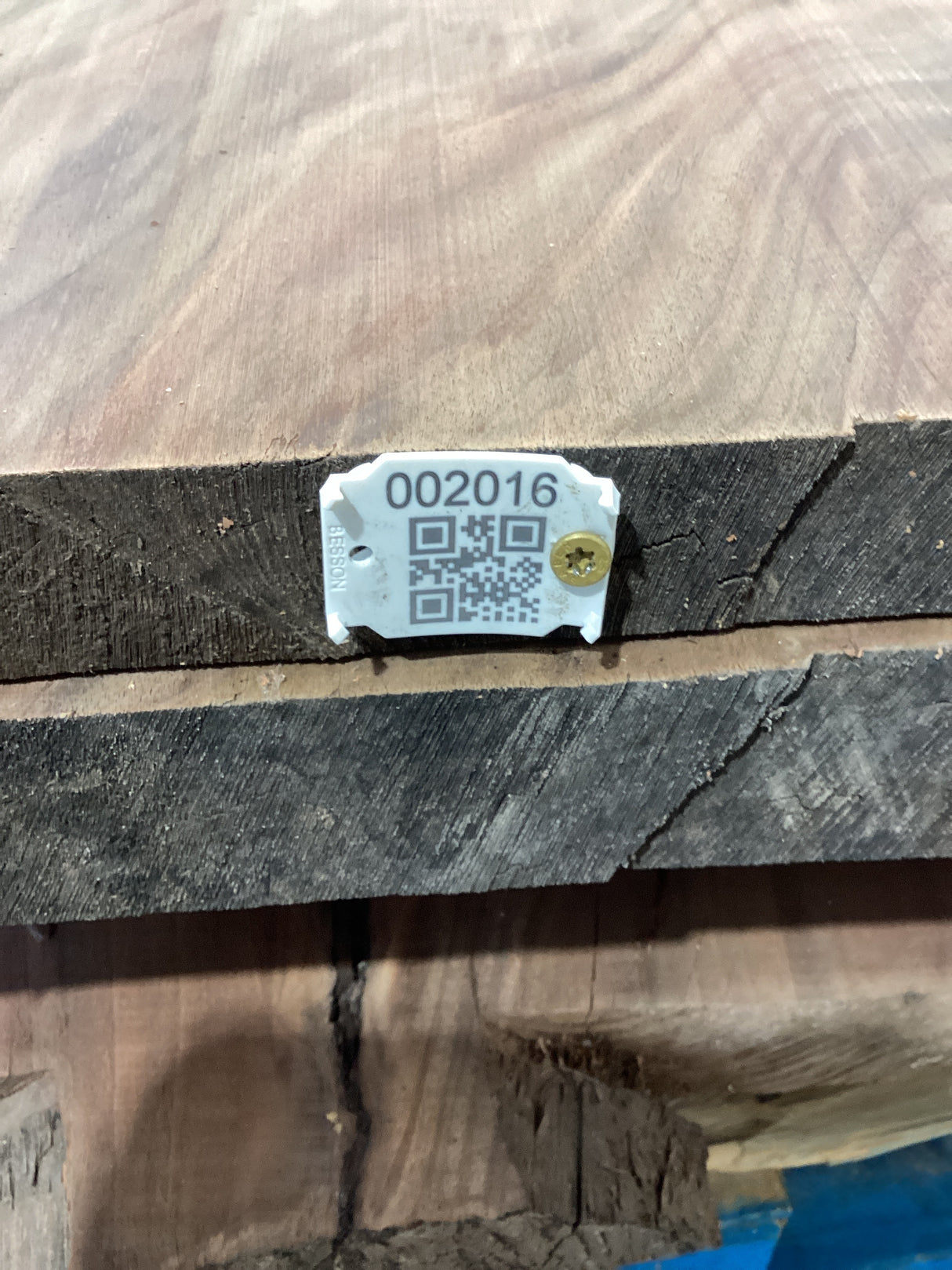 QR label attached to a walnut wood slab.