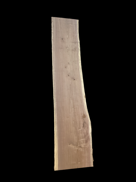 Large walnut wood slab with a black background.