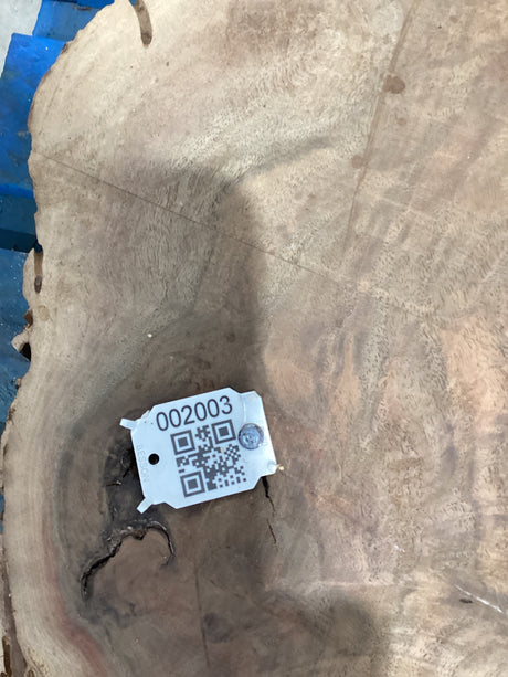QR label attached to walnut wood slab.