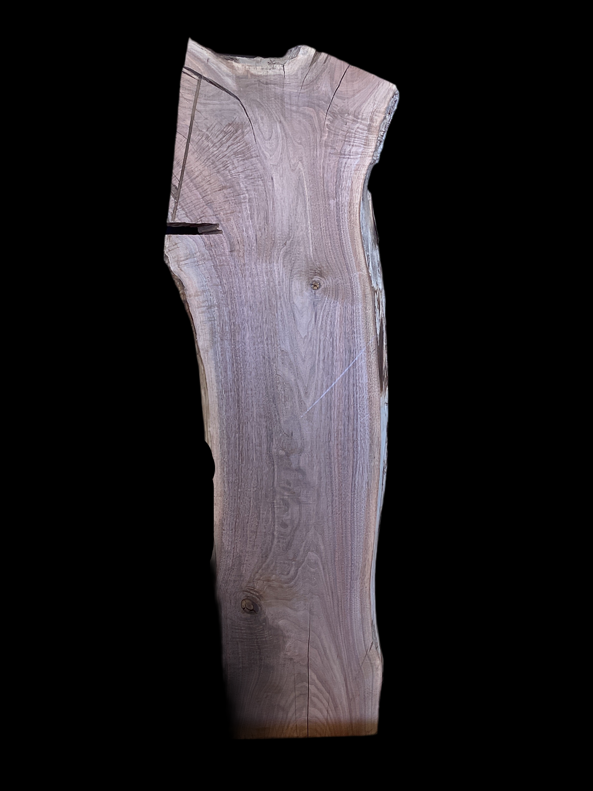 Wooden slab with visible grain and texture on a black background