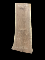 Large walnut wood slab with a black background.