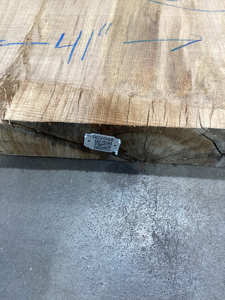 Red oak slab edge with QR code attached.