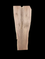 A long walnut slab, wider on one end than the other, and on a black background. 