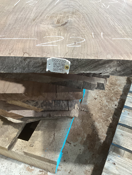 A walnut wood slab with visible grain and Contour, marked with a QR tag.