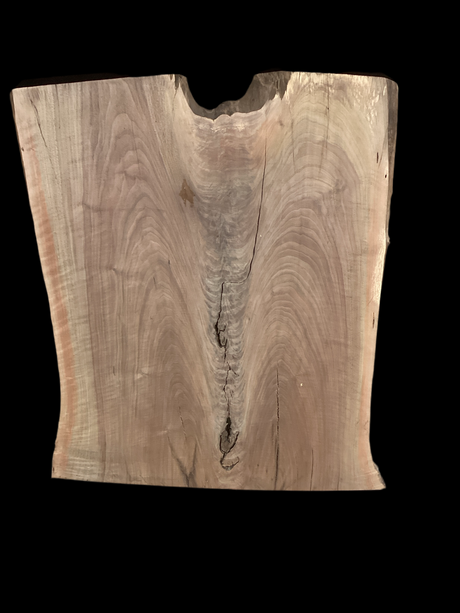 A short walnut slab with a black background. 