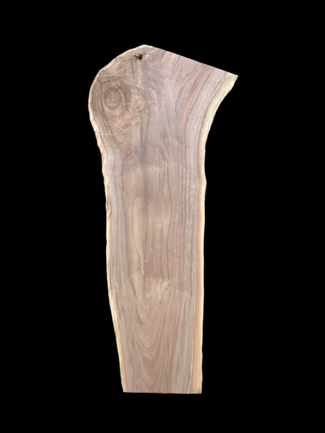 Walnut wood slab with a black background.