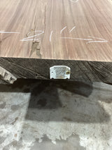A walnut slab sofa table with visible wood grain and some defects, placed on a concrete surface with a QR label attached.