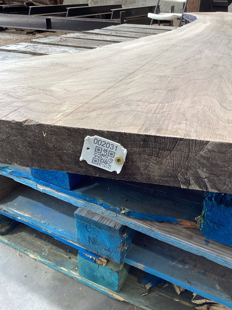 QR label attached to the edge of a walnut slab.