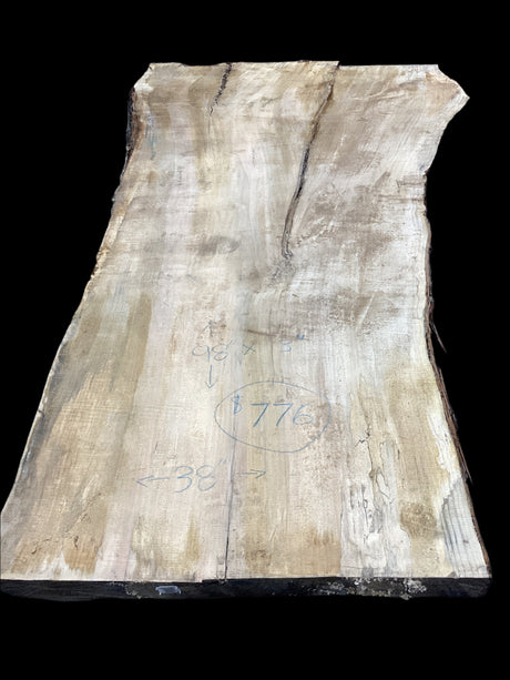 Silver Maple slab showcases distinctive grain patterns and natural character on a black background.