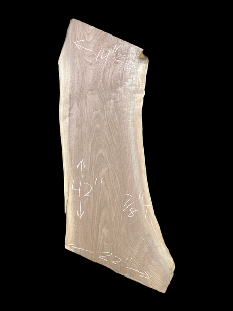 Walnut wood slab with a black background.