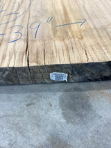 QR label attached to the edge of the red wood slab.