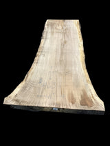 A beige-colored oak wood slab with visible wood grain, positioned on a plain background.