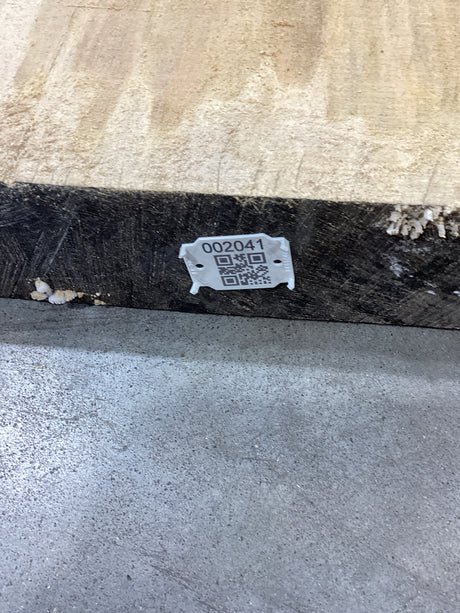 A Silver Maple wood slab edge with QR code attached.