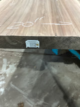 A walnut slab with measurements marked on it, with an attached QR label signifying the sku.