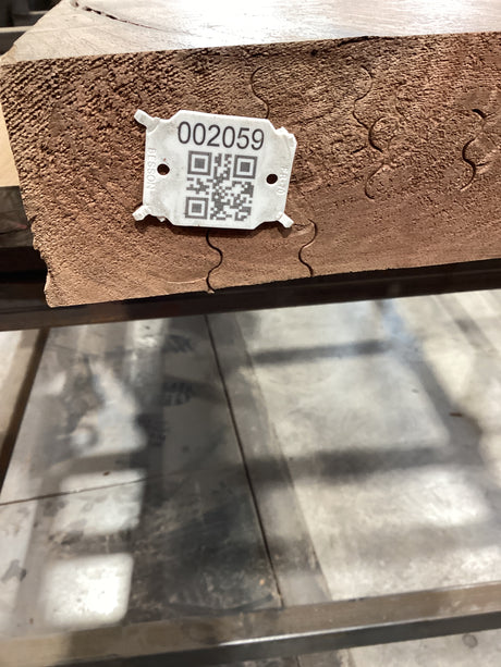 QR label attached to the edge of the walnut wood mantel.