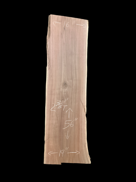 Large walnut wood slab with a black background.