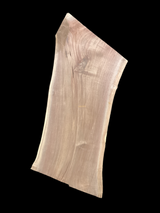 Walnut wood slab with a black background.