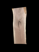 A short walnut slab with a black background. 